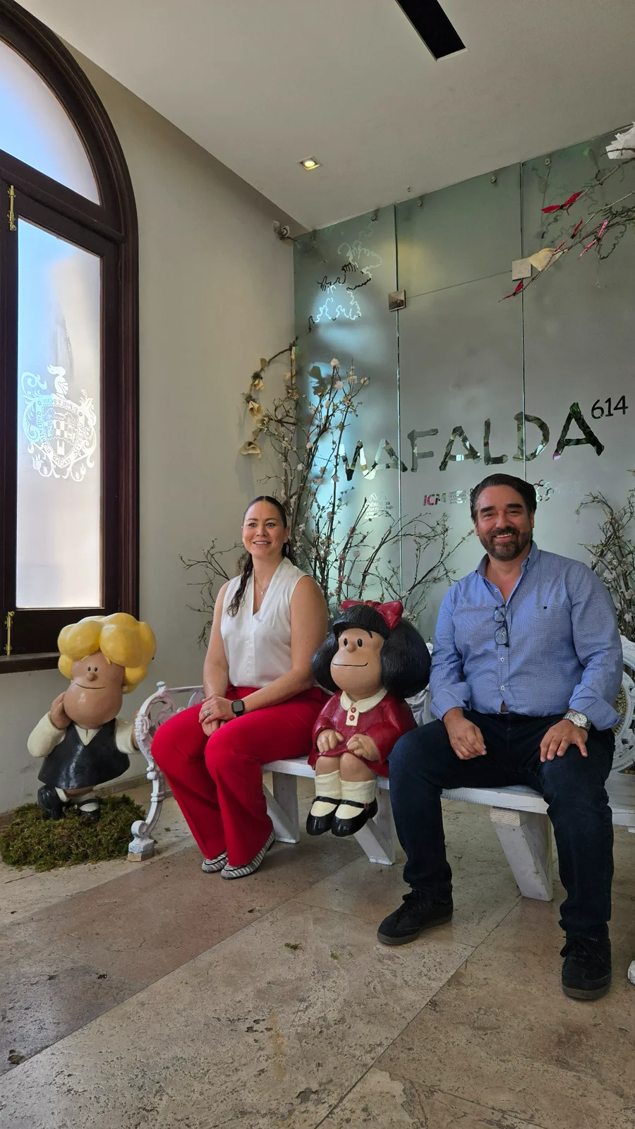 Personas junto a figuras de Mafalda 614 en el acceso